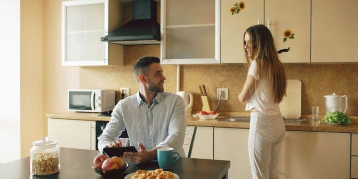 Two people talking at a table at home