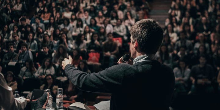 A person standing in front of a room full of people